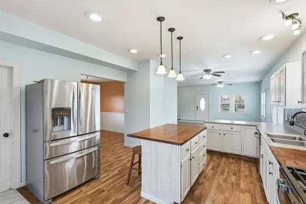 a kitchen with a refrigerator sink and stove