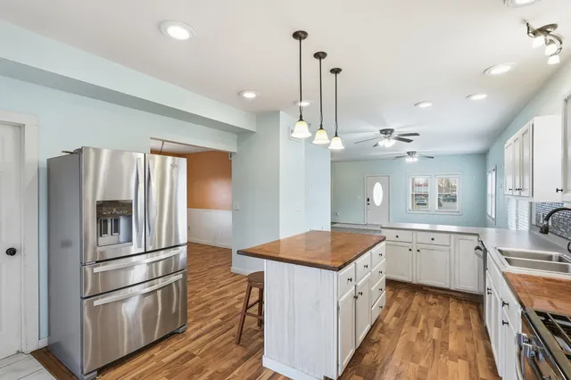 a kitchen with a refrigerator sink and stove