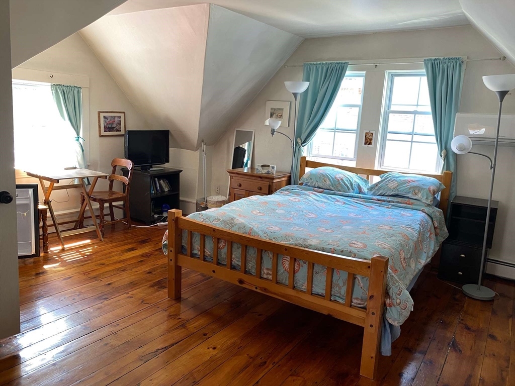 8 May Street Beverly, MA 01915 - Photo 11 of 25 a bed sitting in a spacious bedroom next to a window