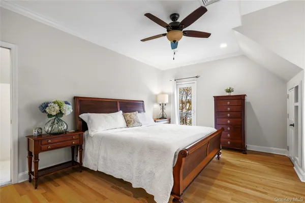 a spacious bedroom with a bed and a dresser