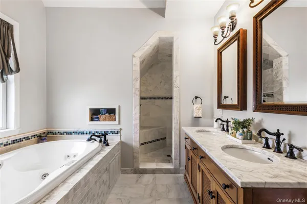 a spacious bathroom with a granite countertop tub sink and mirror