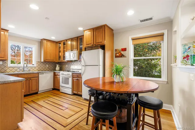a kitchen with a table chairs stove and refrigerator