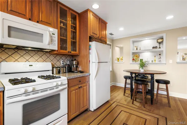 a kitchen with a stove a refrigerator and a dining table
