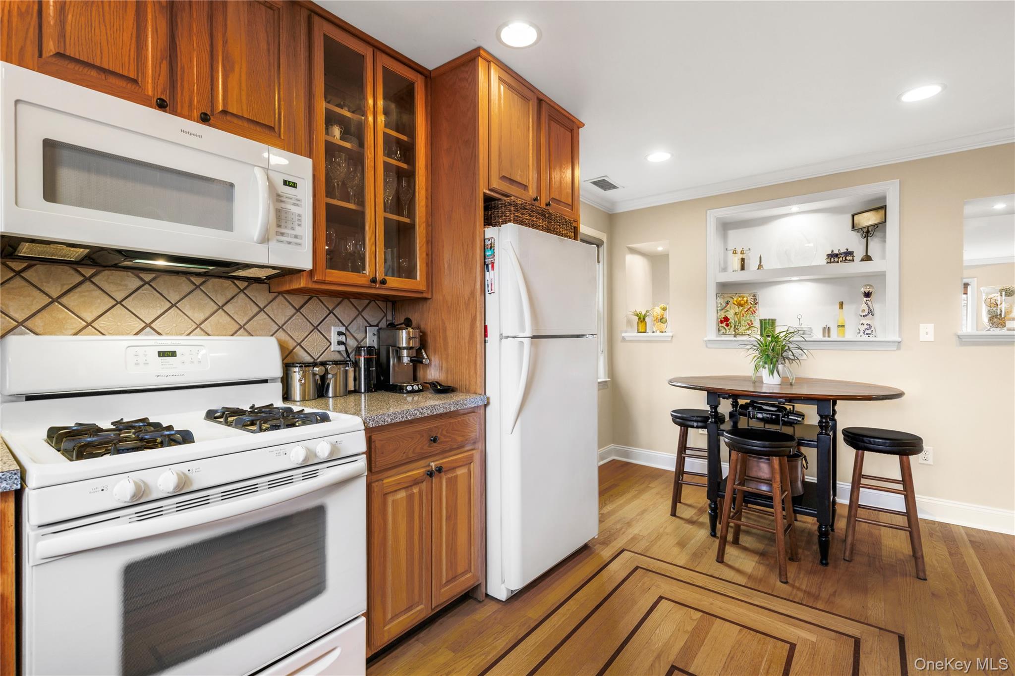 2 Goldwin Street, Unit 2 Rye, NY 10580 - Photo 10 of 28 a kitchen with a stove a refrigerator and a dining table