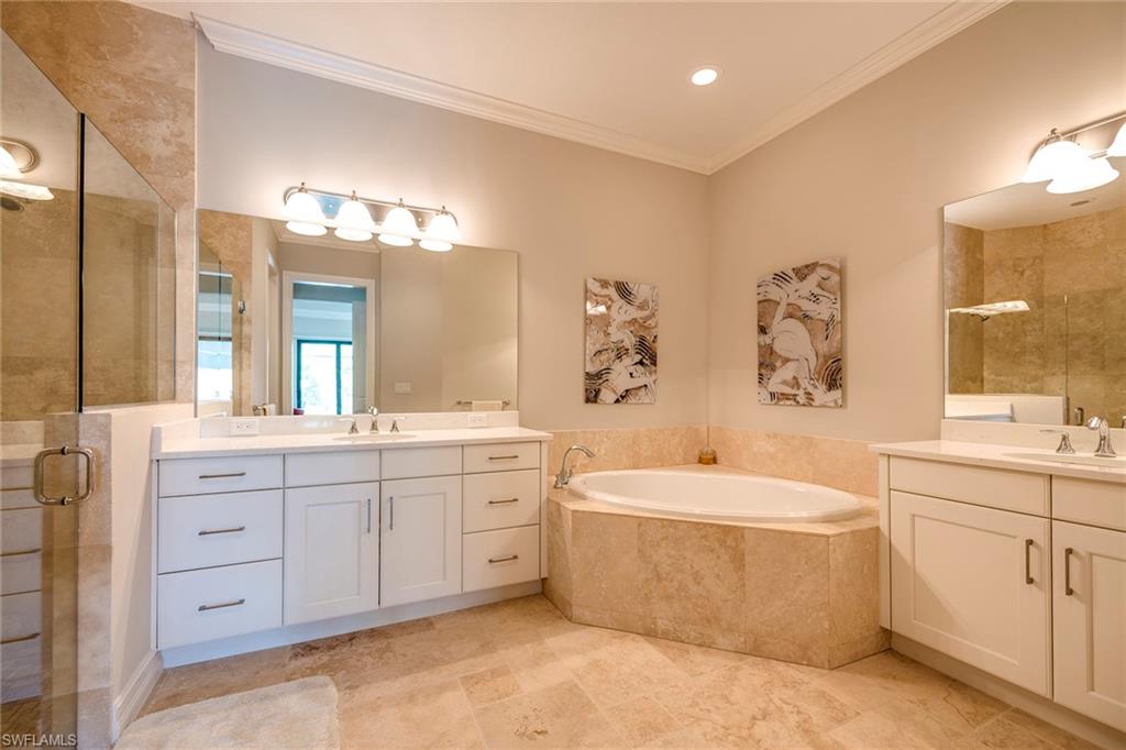 6560 Roma Way Naples, FL 34113 - Photo 12 of 24 a bathroom with a double vanity sink mirror and bathtub