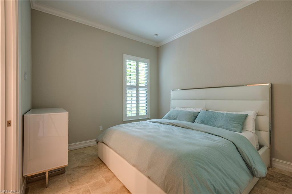 6560 Roma Way Naples, FL 34113 - Photo 13 of 24 a bedroom with a bed and window
