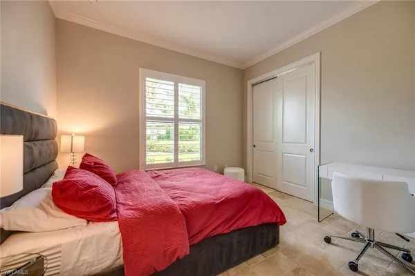 a bedroom with a bed a dresser and chair