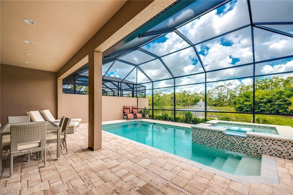 6560 Roma Way Naples, FL 34113 - Photo 19 of 24 a view of a swimming pool with a porch