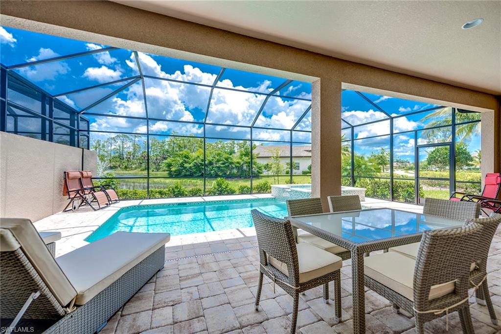 6560 Roma Way Naples, FL 34113 - Photo 21 of 24 a living room with patio furniture and a potted plant