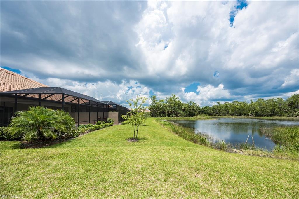 6560 Roma Way Naples, FL 34113 - Photo 22 of 24 a view of a lake with a yard
