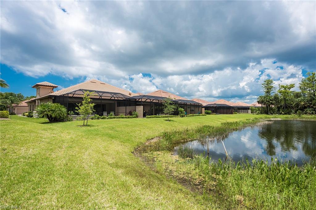 6560 Roma Way Naples, FL 34113 - Photo 23 of 24 a view of a lake with a house in the background