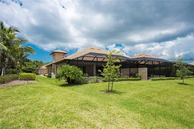 a backyard of a house with a garden and barbeque oven