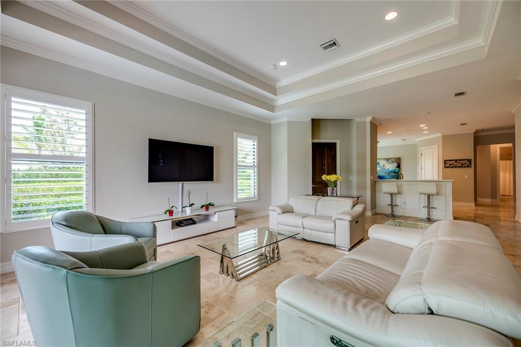 6560 Roma Way Naples, FL 34113 - Photo 6 of 24 a living room with furniture and a flat screen tv