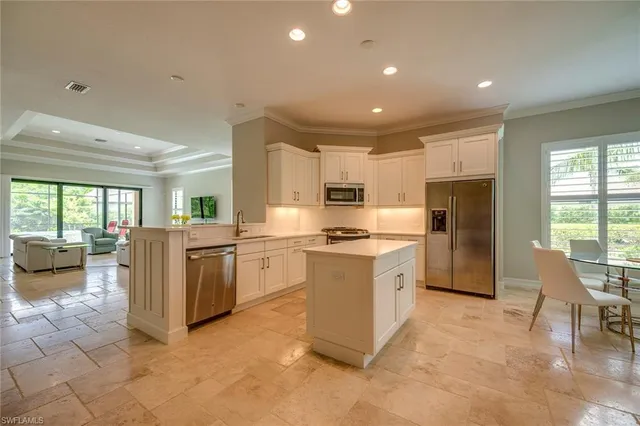 a kitchen with a refrigerator and a sink