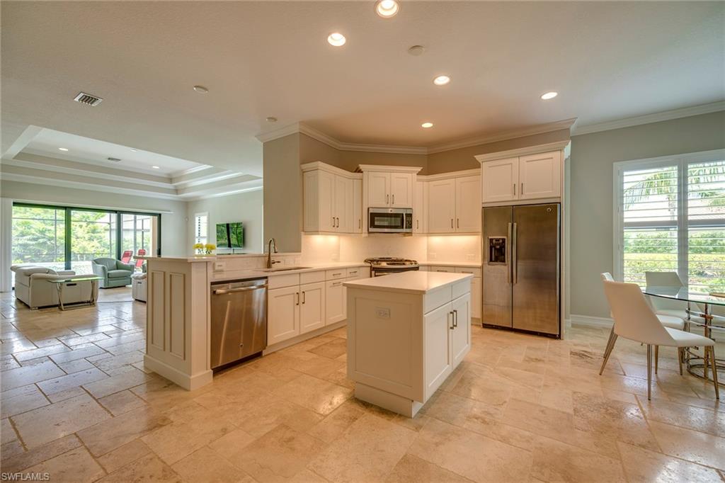 6560 Roma Way Naples, FL 34113 - Photo 9 of 24 a kitchen with a refrigerator and a sink
