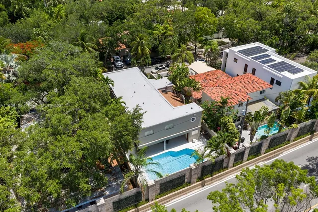 an aerial view of residential house with outdoor space and trees around