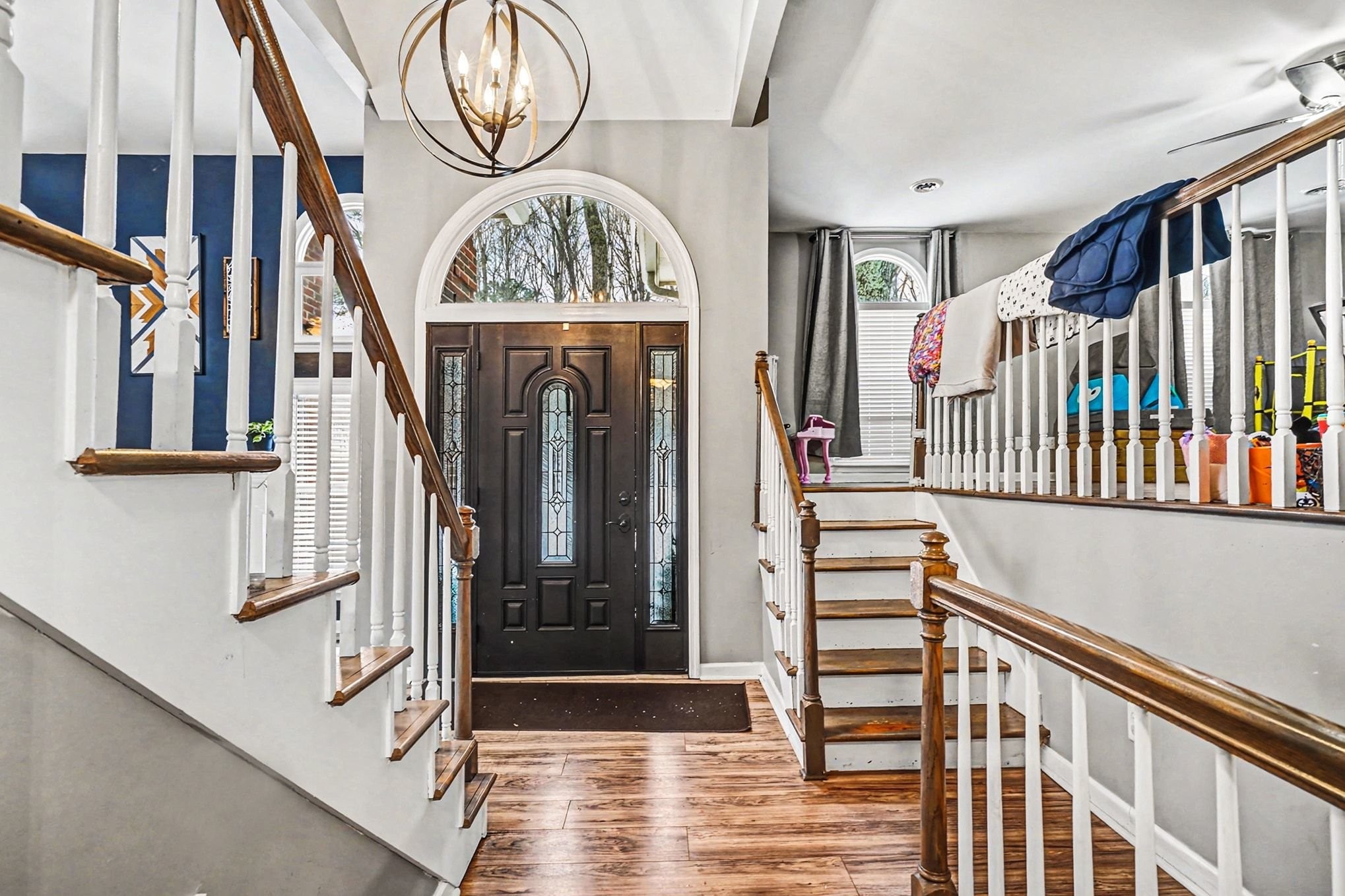 a view of entryway and hall with wooden floor