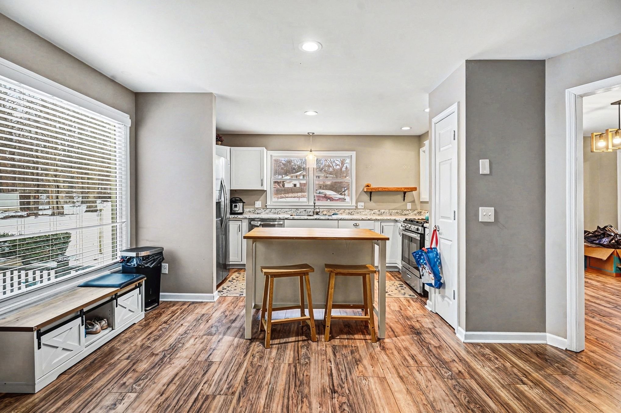 2202 Woodmont Drive Springfield, TN 37172 - Photo 11 of 43 a kitchen with kitchen island granite countertop wooden floors and white stainless steel appliances