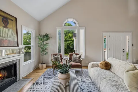 a living room with furniture fireplace and window
