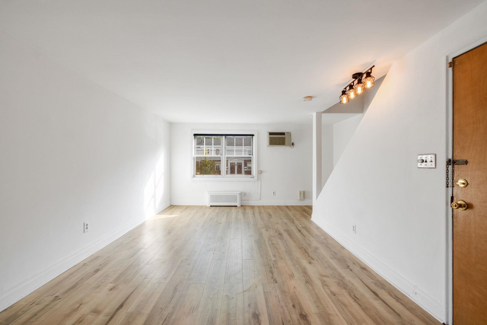 25 B Hastings Avenue, Unit B Rutherford, NJ 07070 - Photo 3 of 16 an empty room with wooden floor and windows