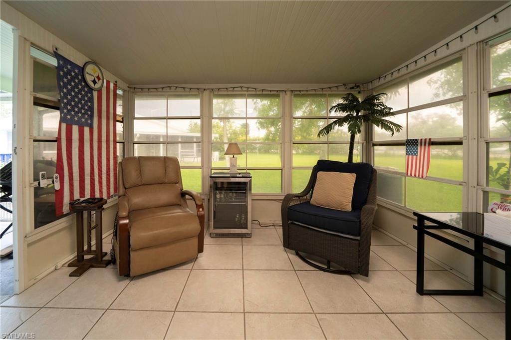 4 Desert Candle Circle Lehigh Acres, FL 33936 - Photo 19 of 36 a living room with furniture and a floor to ceiling window