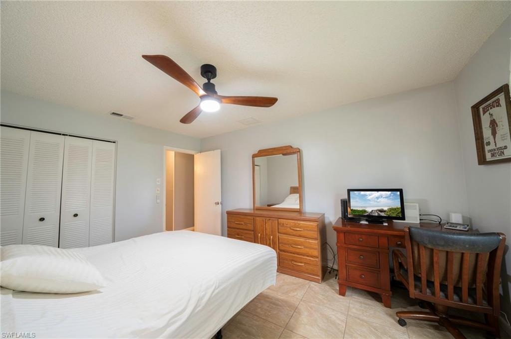 4 Desert Candle Circle Lehigh Acres, FL 33936 - Photo 10 of 36 a bedroom with a bed and a view of kitchen