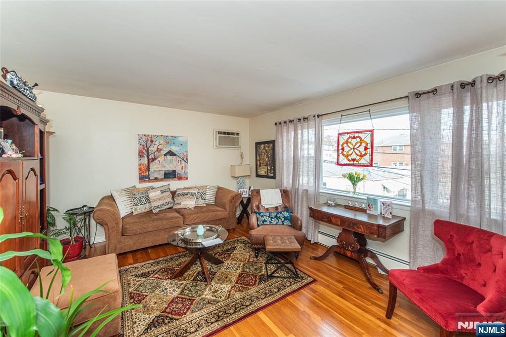 233 9th Street Fairview, NJ 07022 - Photo 2 of 7 a living room with furniture and a window