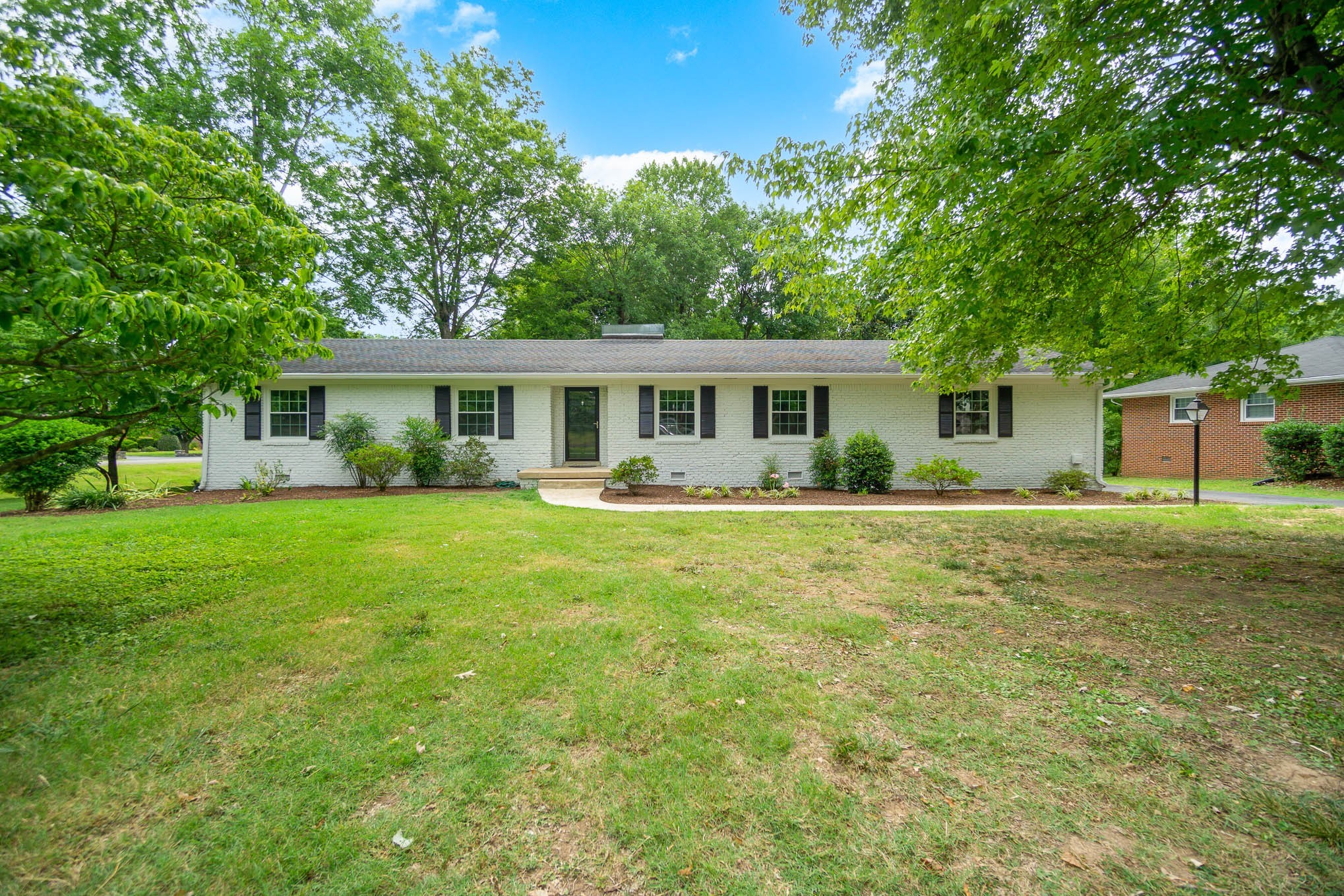 1401 Manor Road Columbia, TN 38401 - Photo 1 of 35 a front view of a house with a yard table and chairs