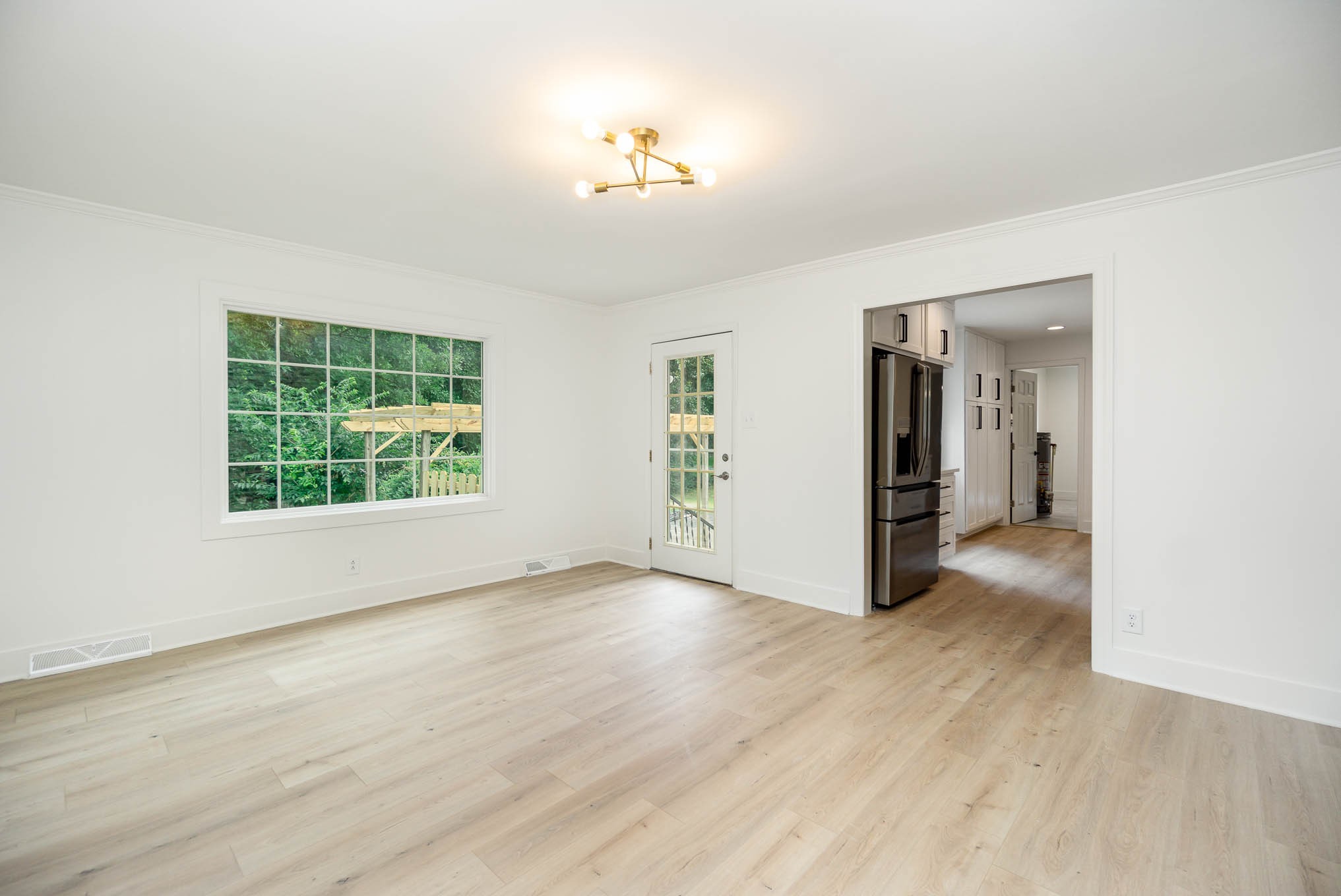1401 Manor Road Columbia, TN 38401 - Photo 11 of 35 an empty room with wooden floor and a window