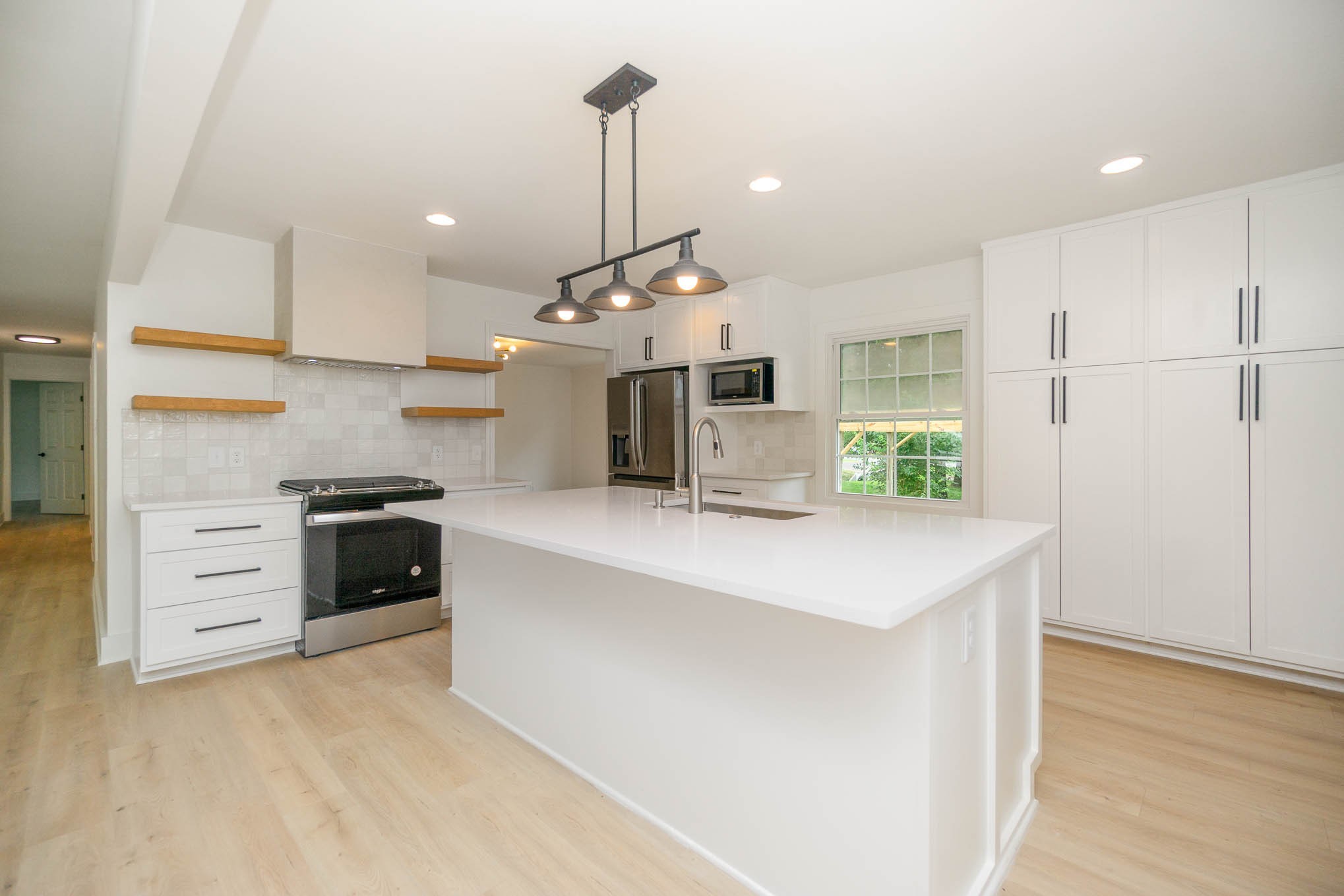 1401 Manor Road Columbia, TN 38401 - Photo 6 of 35 a large kitchen with stainless steel appliances a large counter top a stove a chimney a sink and a refrigerator