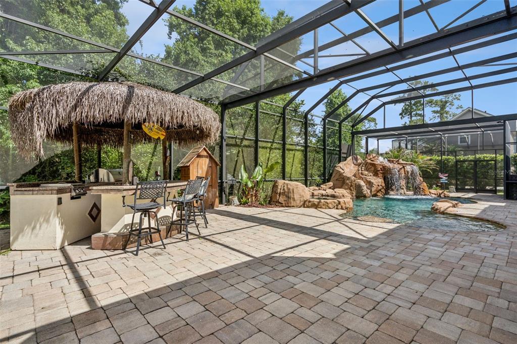 908 Croton Road Celebration, FL 34747 - Photo 59 of 86 a view of a patio with a table and chairs under an umbrella