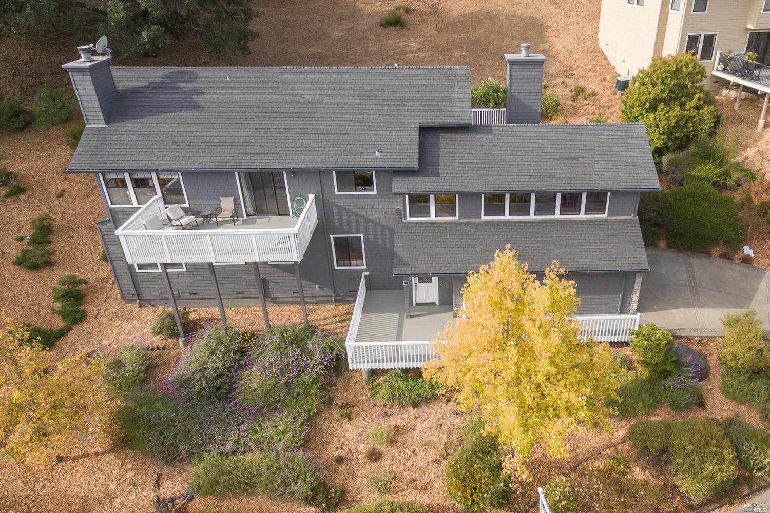 a front view of a house with a yard and fountain