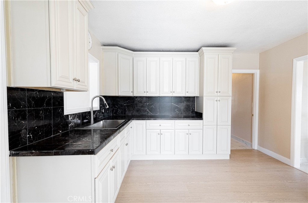 11711 Carmine Street Riverside, CA 92505 - Photo 15 of 33 a kitchen with stainless steel appliances and white cabinets