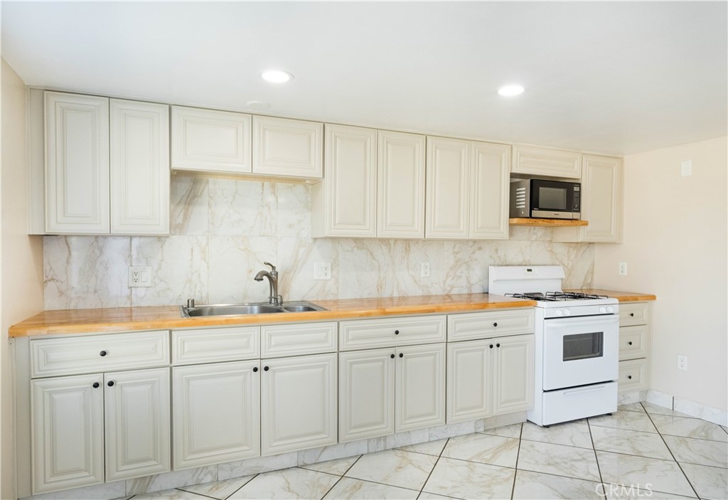 11711 Carmine Street Riverside, CA 92505 - Photo 26 of 33 a kitchen that has a sink and cabinets