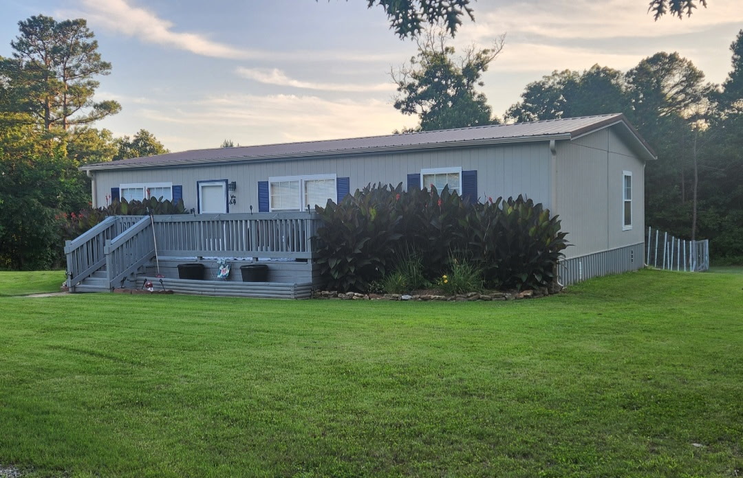 57443 667th Colcord, OK 74338 - Photo 1 of 51 Expansive lawn with a raised wooden deck, exterior siding, and a metal roof
