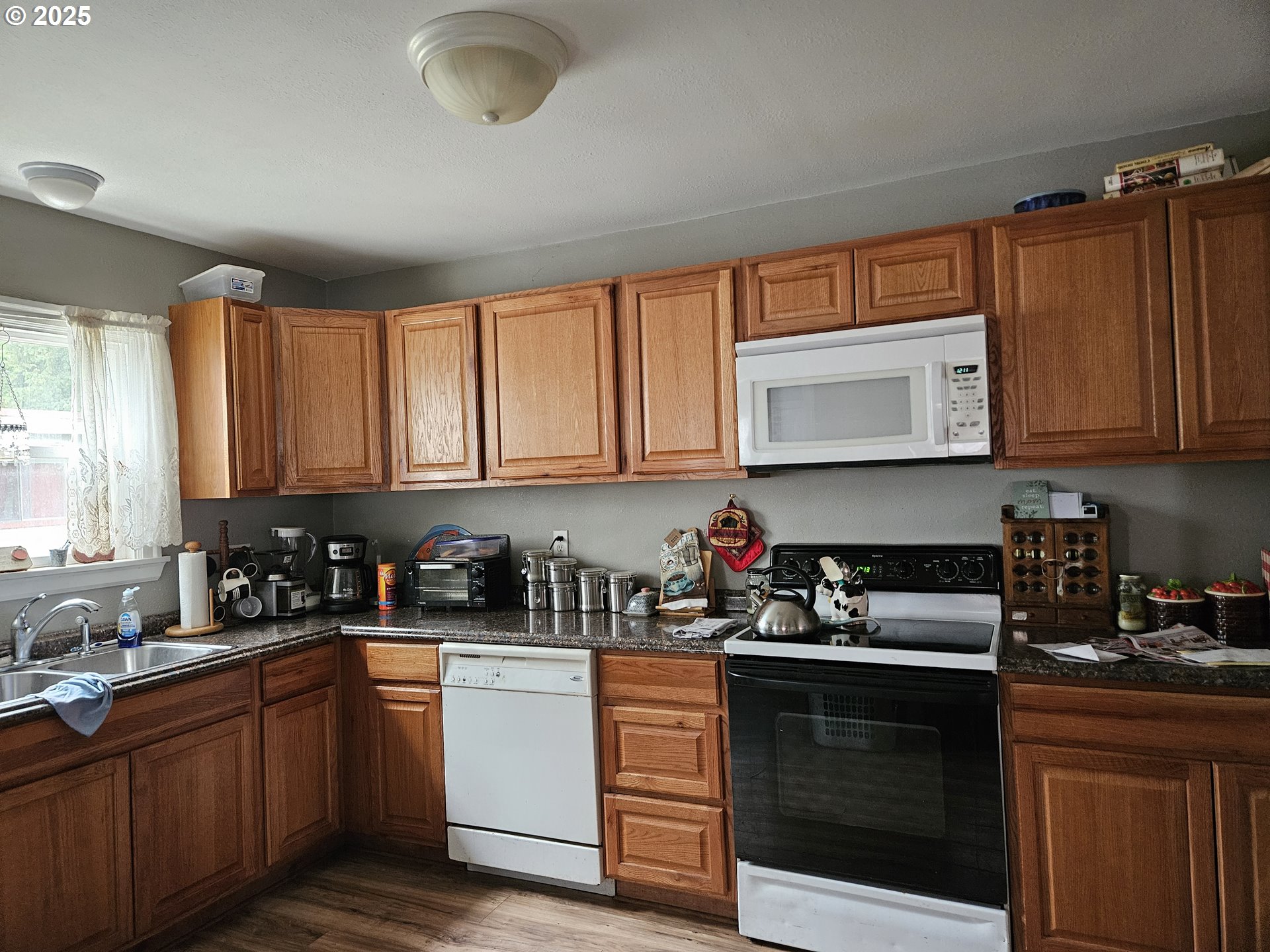749 Southwest Washington Street Dallas, OR 97338 - Photo 5 of 14 a kitchen with sink a microwave and cabinets