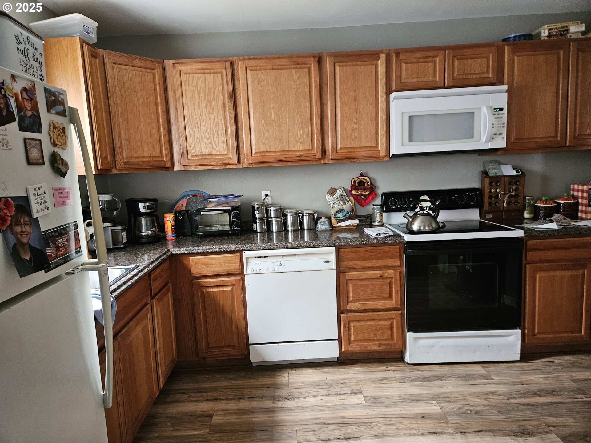 749 Southwest Washington Street Dallas, OR 97338 - Photo 6 of 14 a kitchen with stainless steel appliances granite countertop a stove a sink dishwasher and a microwave with wooden cabinets