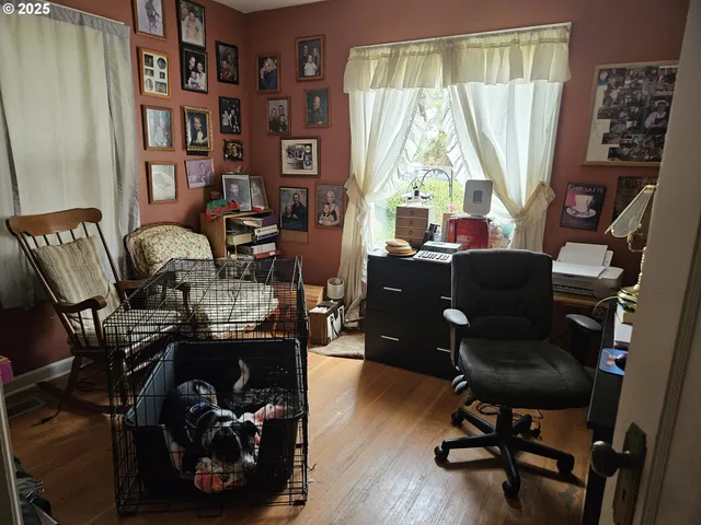 a view of a workspace with furniture and a window