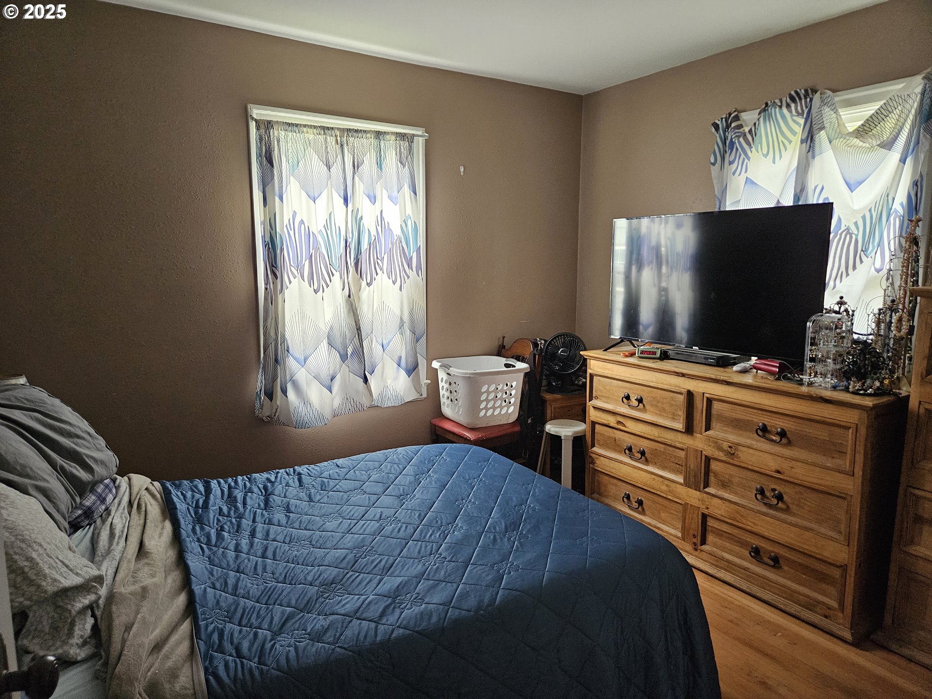 749 Southwest Washington Street Dallas, OR 97338 - Photo 9 of 14 a bedroom with a bed and flat screen tv