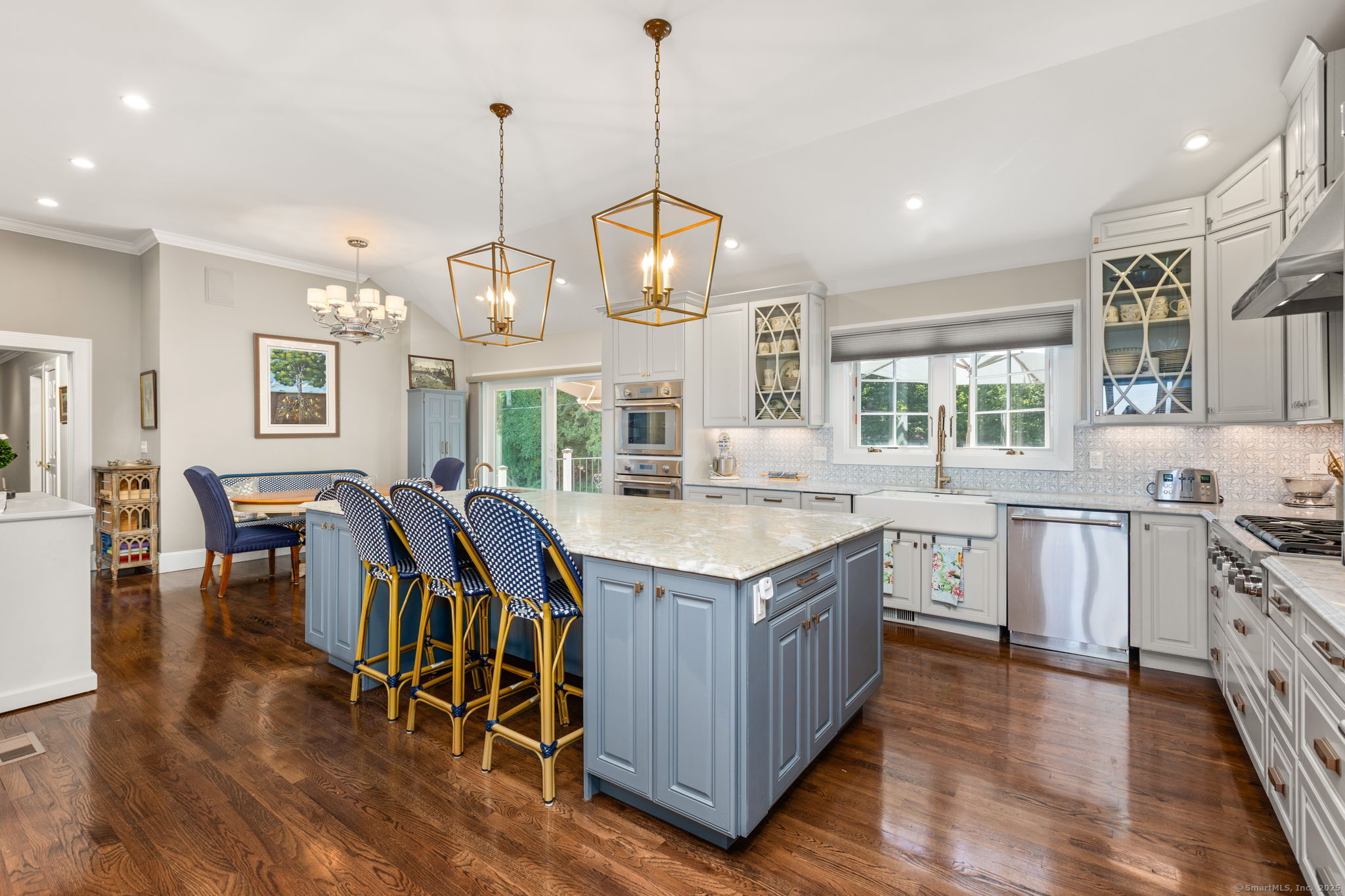 803 North Salem Road Ridgefield, CT 06877 - Photo 14 of 40 a kitchen with stainless steel appliances granite countertop a stove a sink dishwasher a dining table and chairs with wooden floor