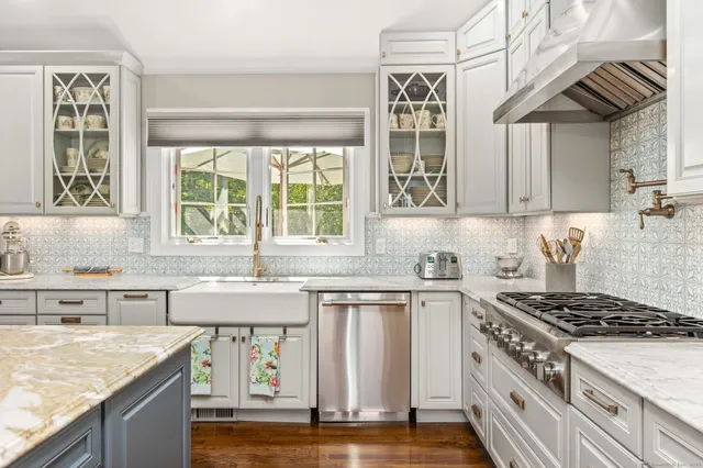a kitchen with stainless steel appliances granite countertop a stove and a sink