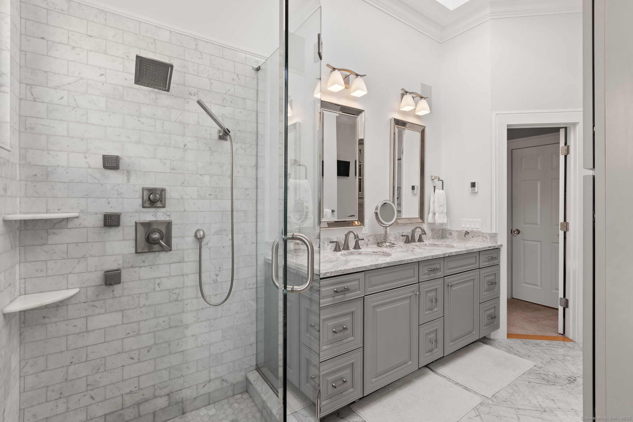 803 North Salem Road Ridgefield, CT 06877 - Photo 22 of 40 a bathroom with a double vanity sink a mirror and a shower