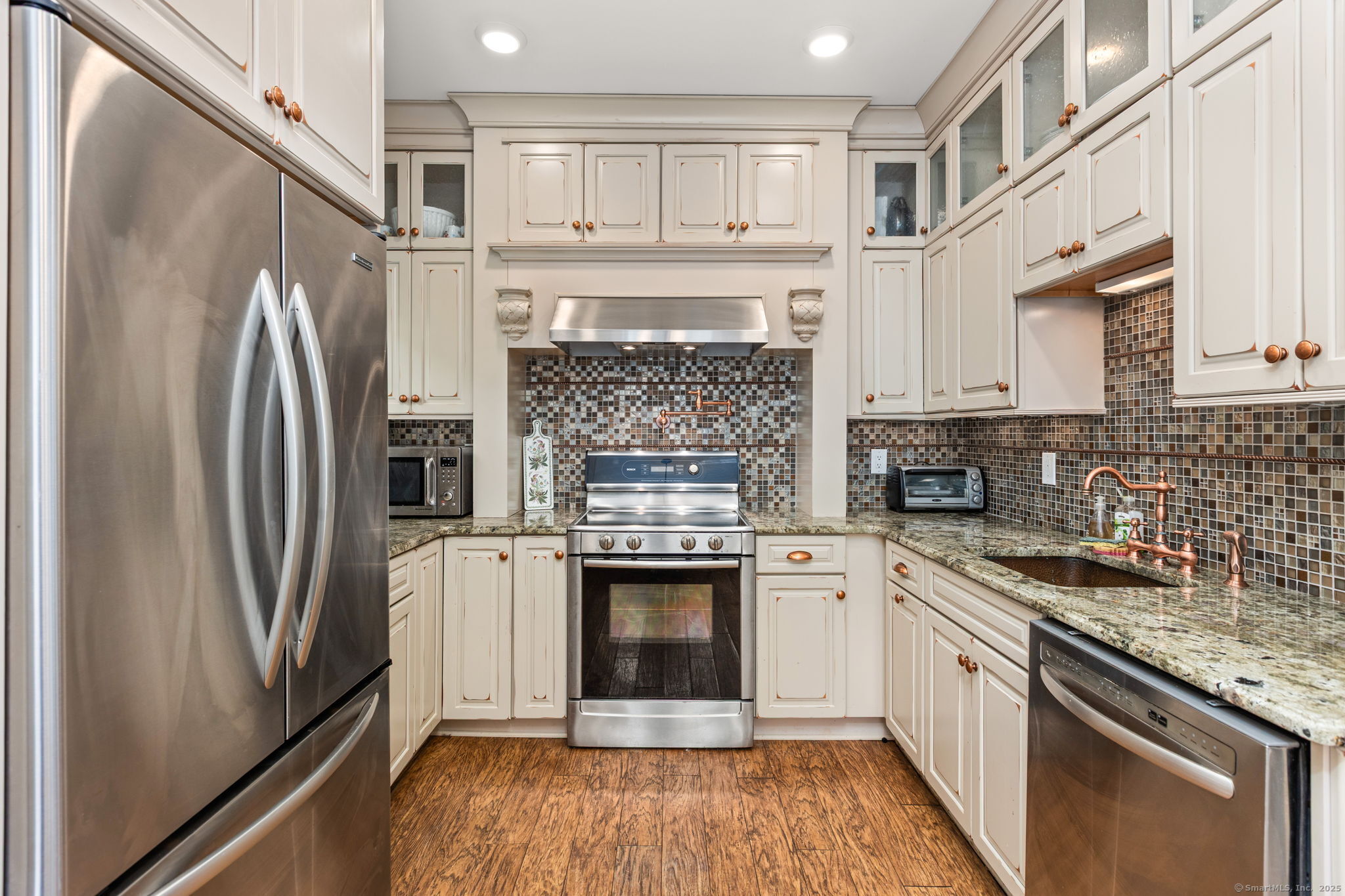803 North Salem Road Ridgefield, CT 06877 - Photo 31 of 40 a kitchen with granite countertop a refrigerator stove and cabinets