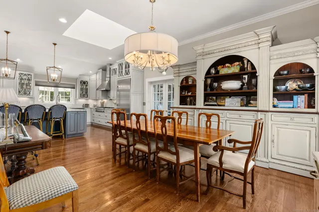 a view of a dining room with furniture and a chandelier