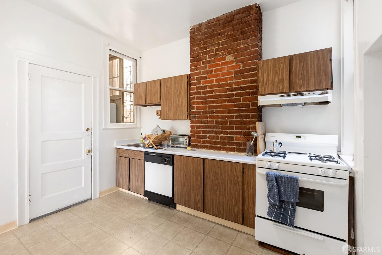 1968 Post Street San Francisco, CA 94115 - Photo 15 of 21 a kitchen with stainless steel appliances granite countertop a stove and a sink