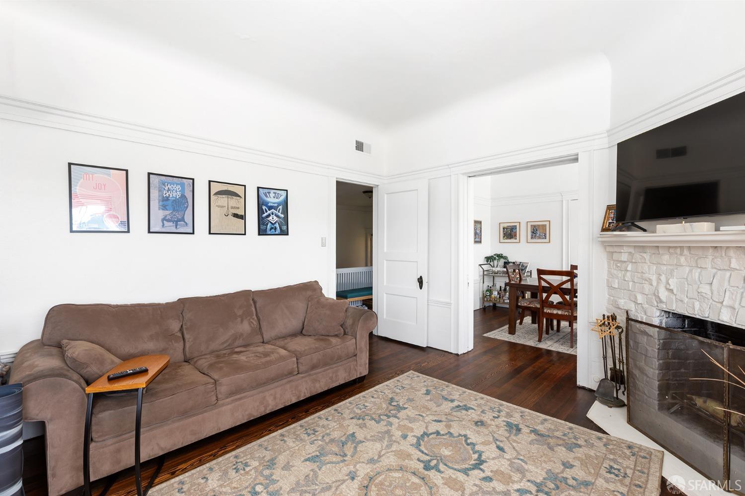 1968 Post Street San Francisco, CA 94115 - Photo 7 of 21 a living room with furniture a flat screen tv and a fireplace