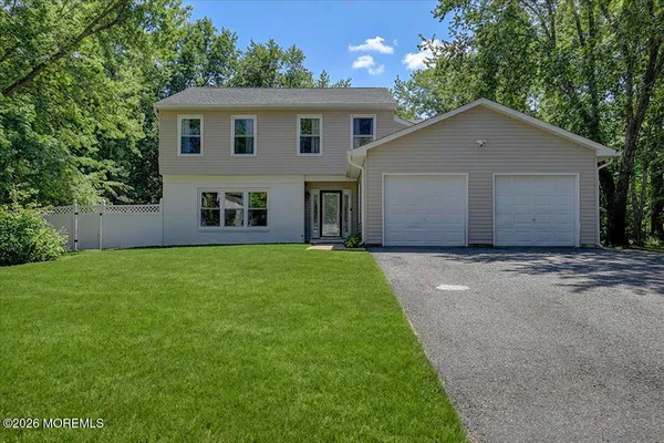 a front view of house with yard and green space