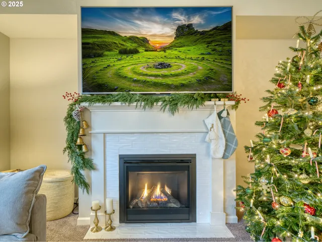 a living room with a fireplace and a potted plant