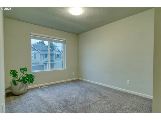 a view of an empty room and a window