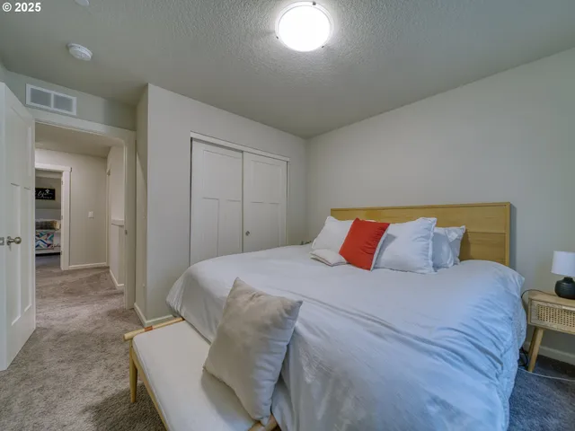 a bedroom with a bed and a mirror